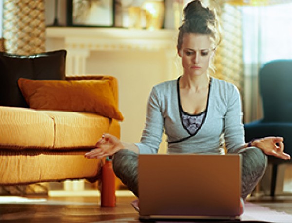 sports woman watching yoga videos on internet via laptop