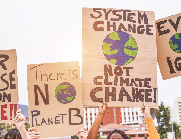 Group of demonstrators on road, young people from different culture and race fight for climate change – Global warming and enviroment concept – Focus on banners